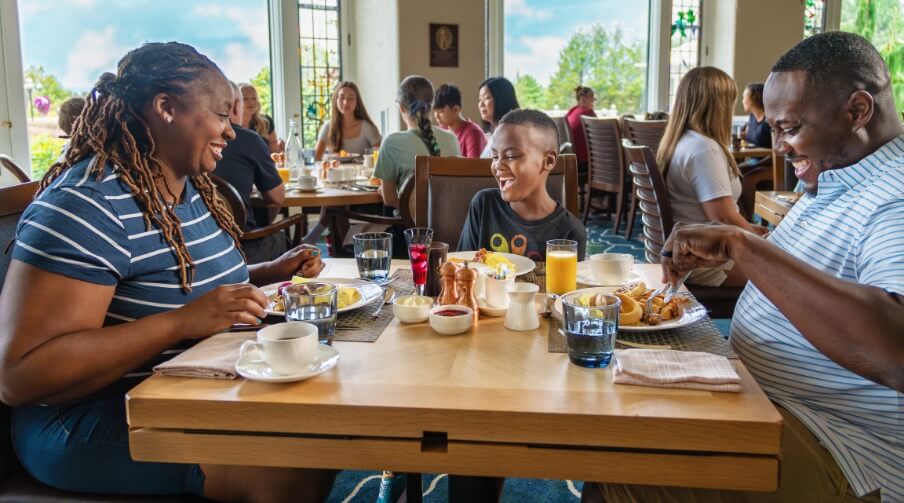 Family of three eating breakfast inside of The Hotel Hershey.