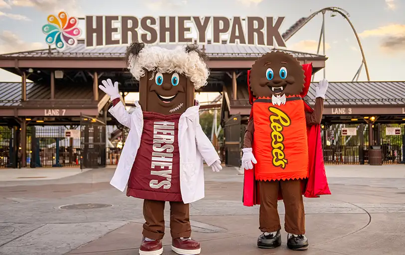 Hersheypark Characters posing in Halloween Costumes in front of front gate
