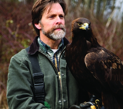 Falcony trainer holding Falcony on his arm.